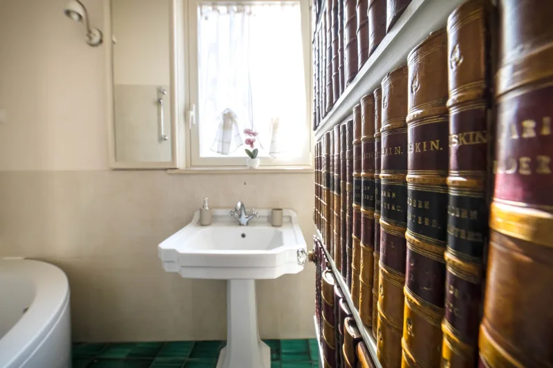 Bathroom with pedestal basin and green tiled floor