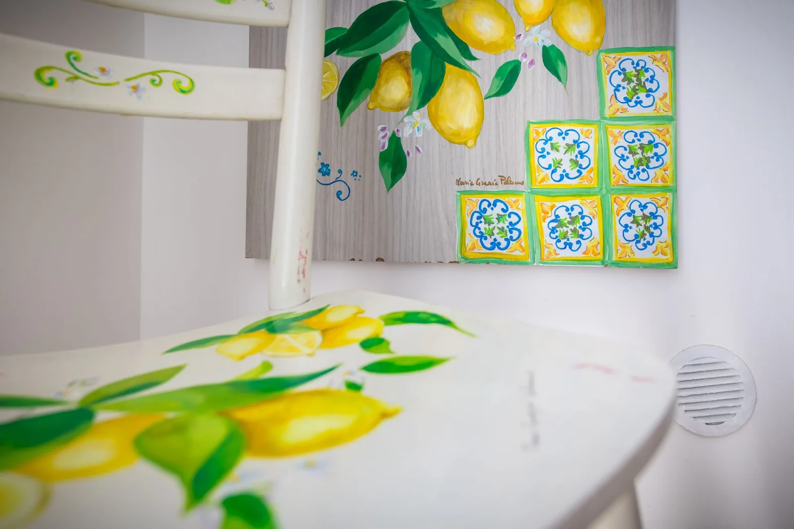 Lemon-painted chair and majolica tiles