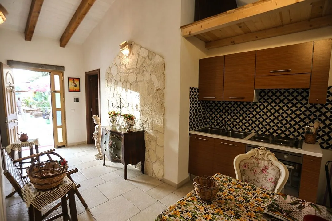 Living and kitchen area with wooden beams